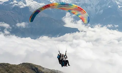 Paraglider flying over Cusco Andes - Sam's Zipline